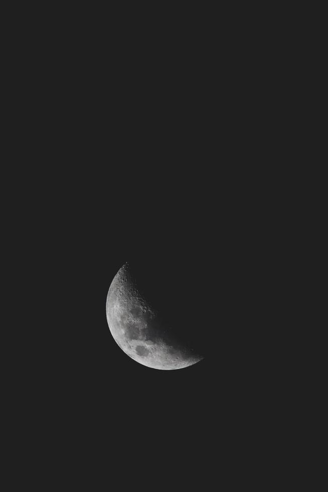 Crescent moon in dark sky photo