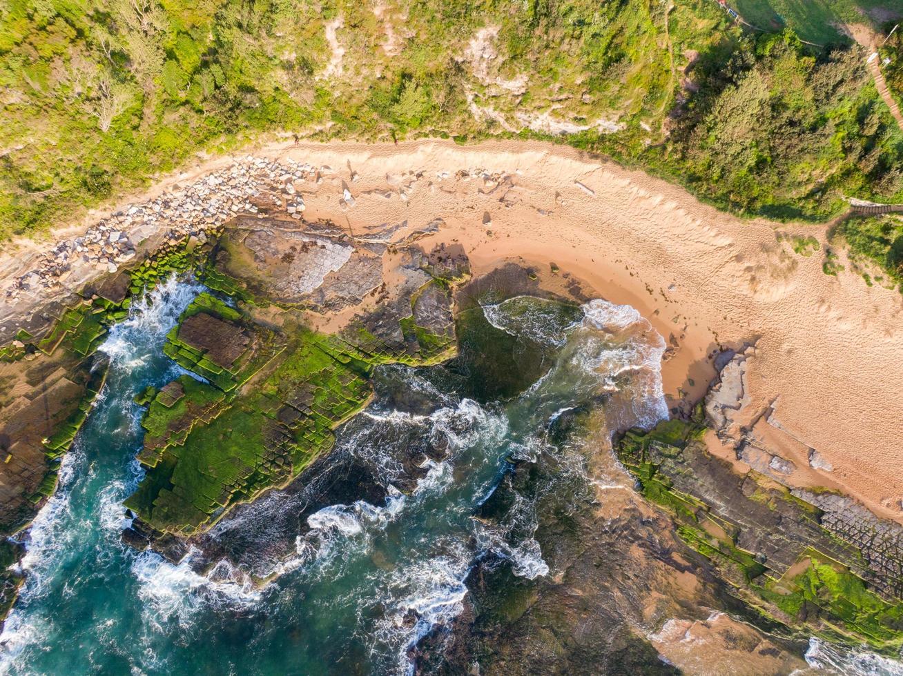 Aerial view of beach with rocks and cliffs photo