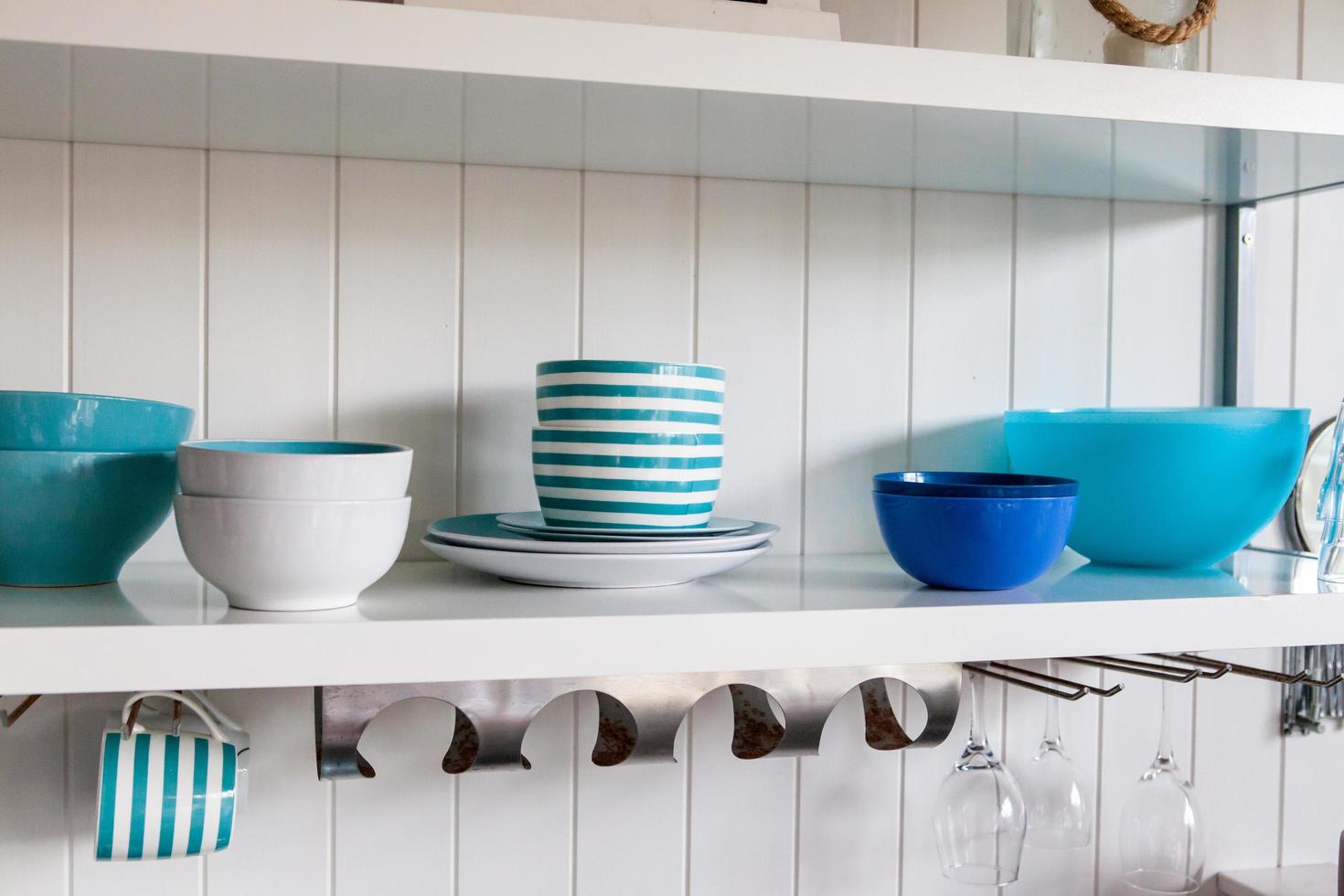 Assorted ceramic bowls on a white shelf photo
