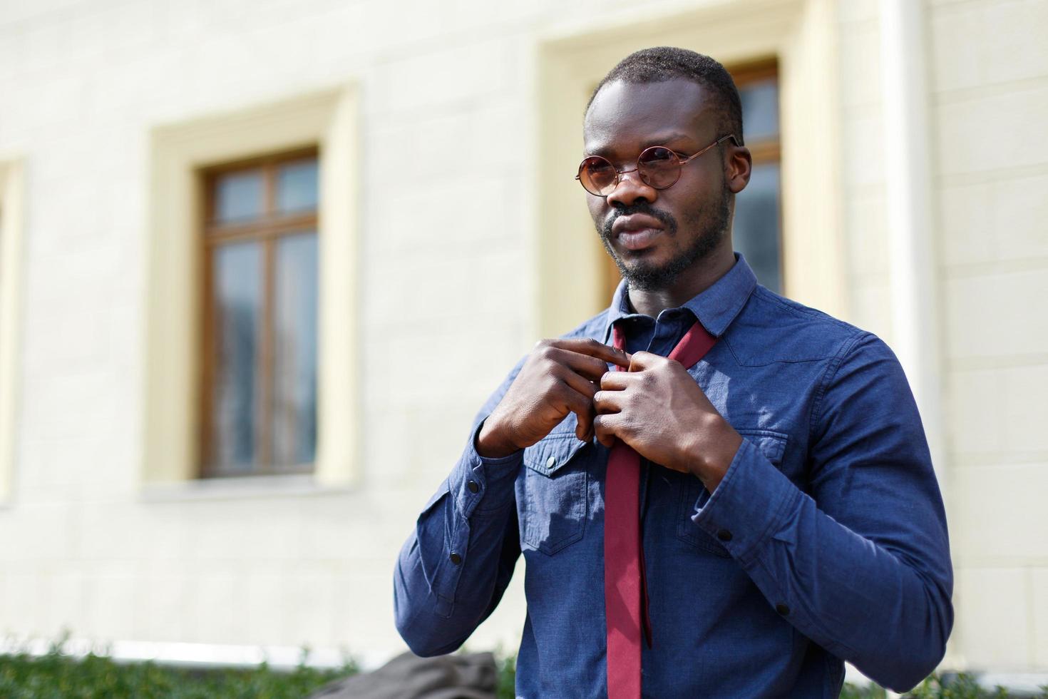 Handsome man fixes his tie photo