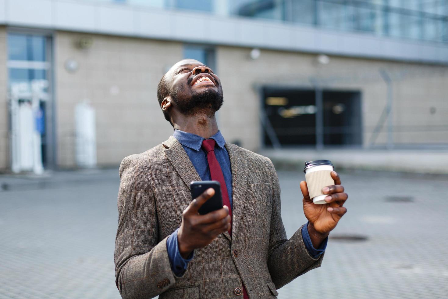 Happy African American man looks lucky photo