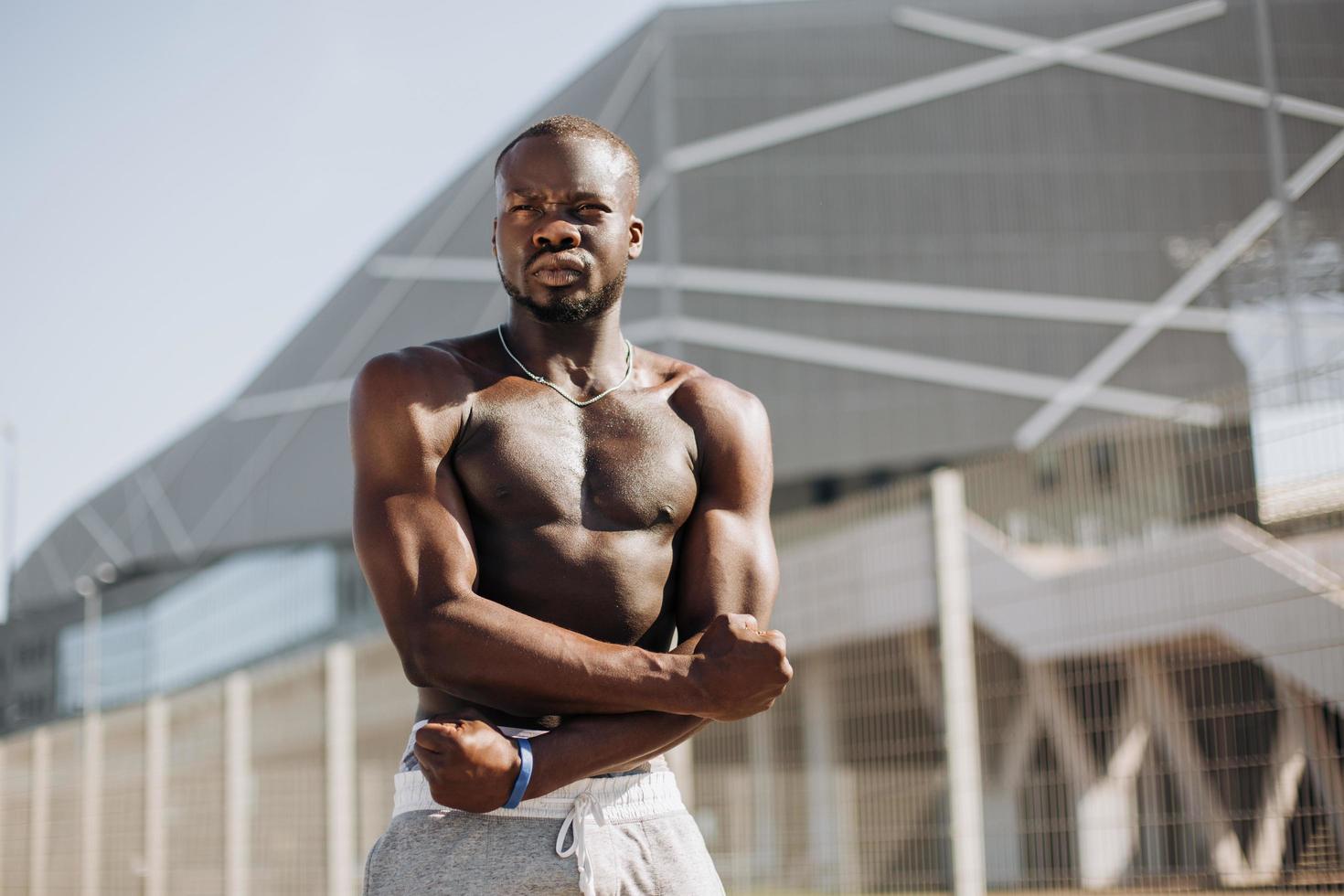 Man with muscles posing after a workout photo