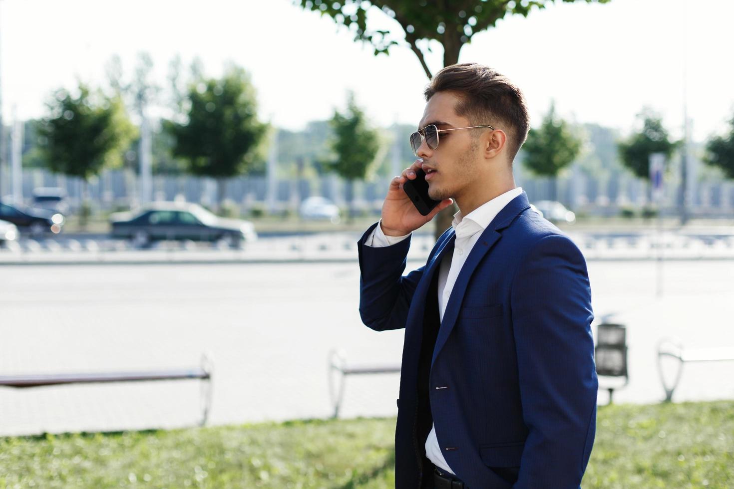 Man in a suit walking and talking on the phone photo