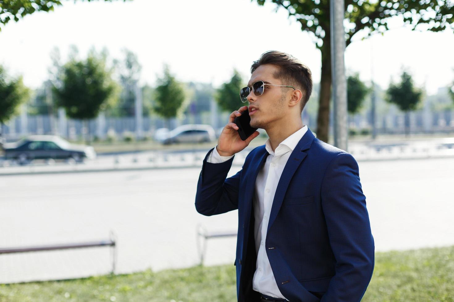 Man in a business suit talking on the phone photo