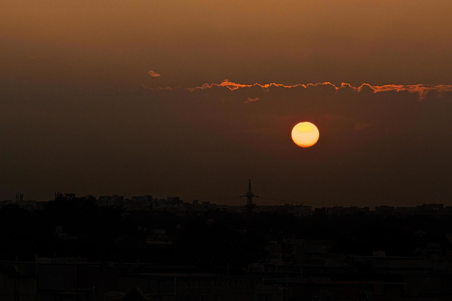 Setting sun in a dark sky photo