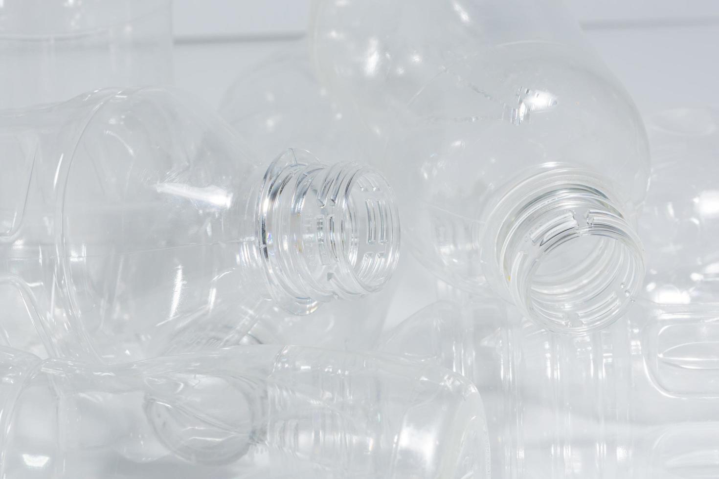 Empty plastic bottles on white background photo