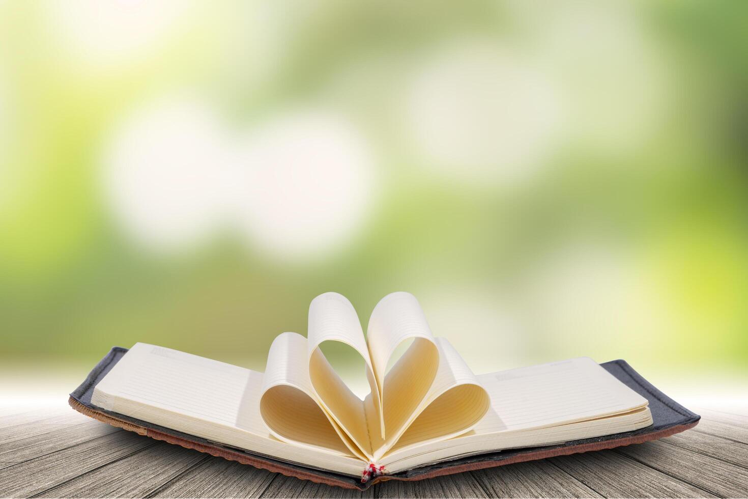 Notebook on wood floor with bokeh background photo