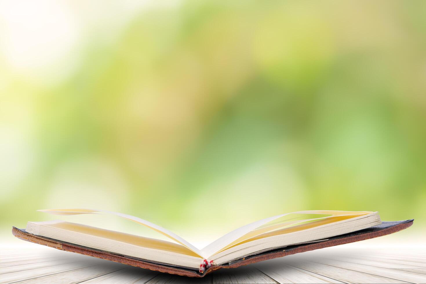 Book on wood floor with bokeh background photo