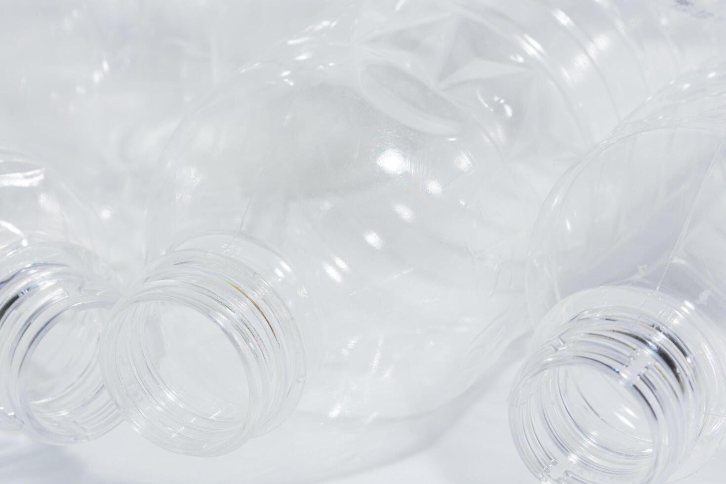 Empty plastic bottles on white background photo