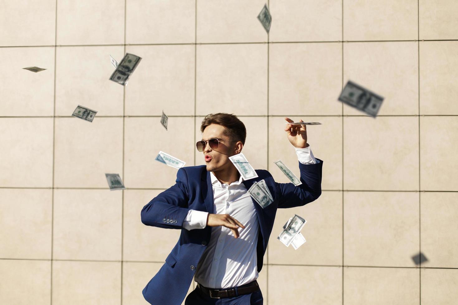 Dollars flying around a businessman photo
