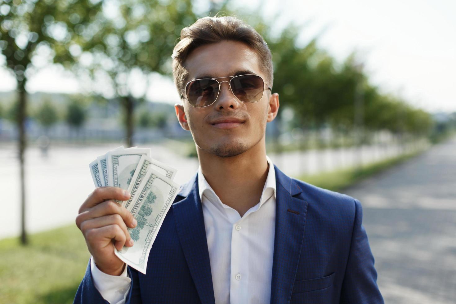 Man holding a bunch of money photo