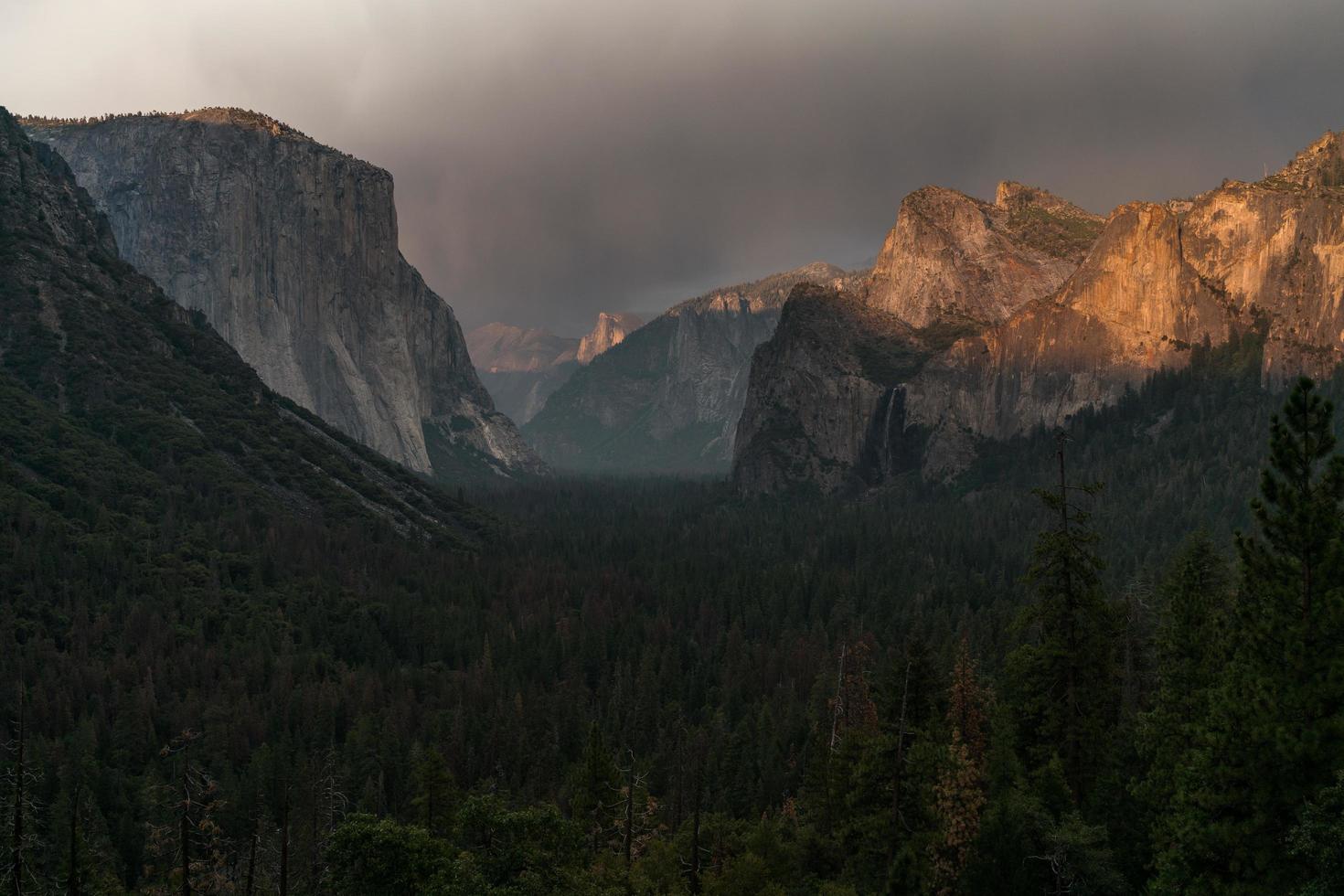 Golden sun shower with rocky mountain background photo