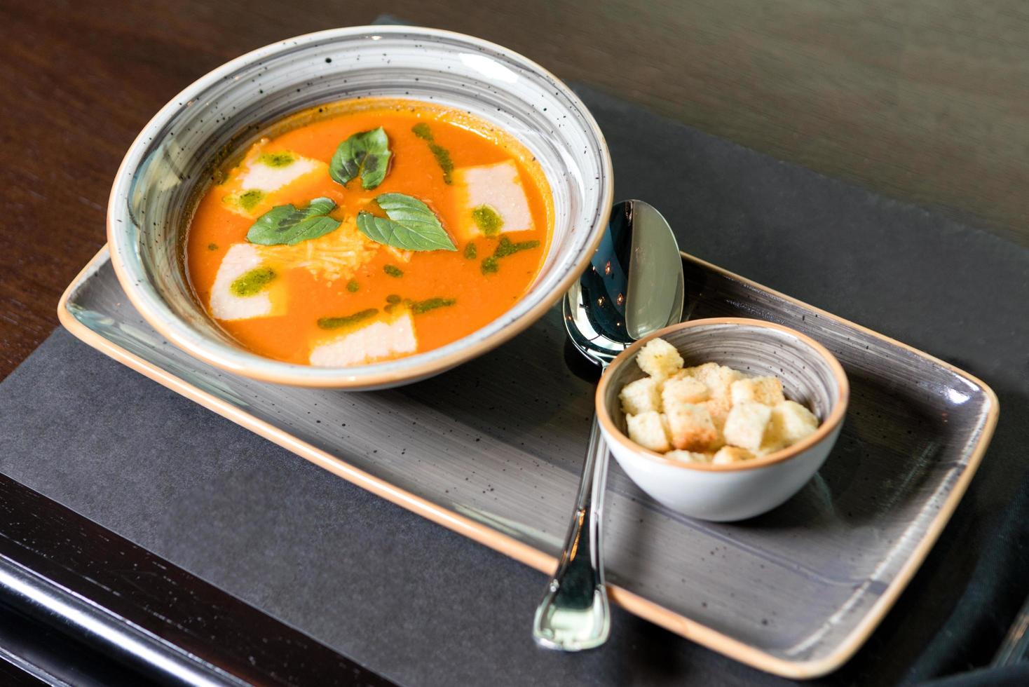 Tasty soup with bread crumbs on the plate photo