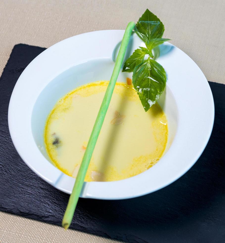 Organic green soup in a white bowl photo