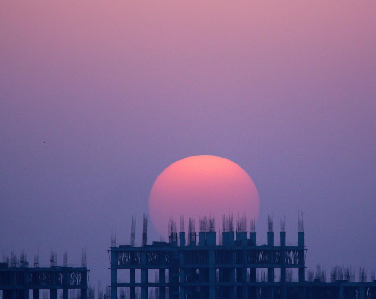 Colorful sunset over a building in construction photo
