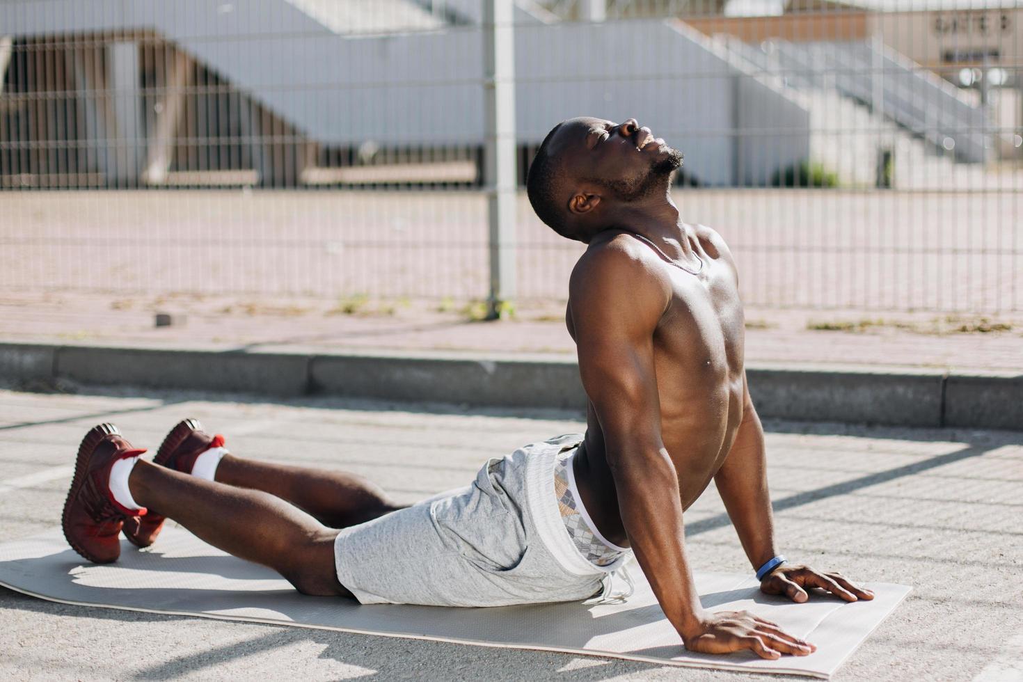 Man doing yoga outside photo