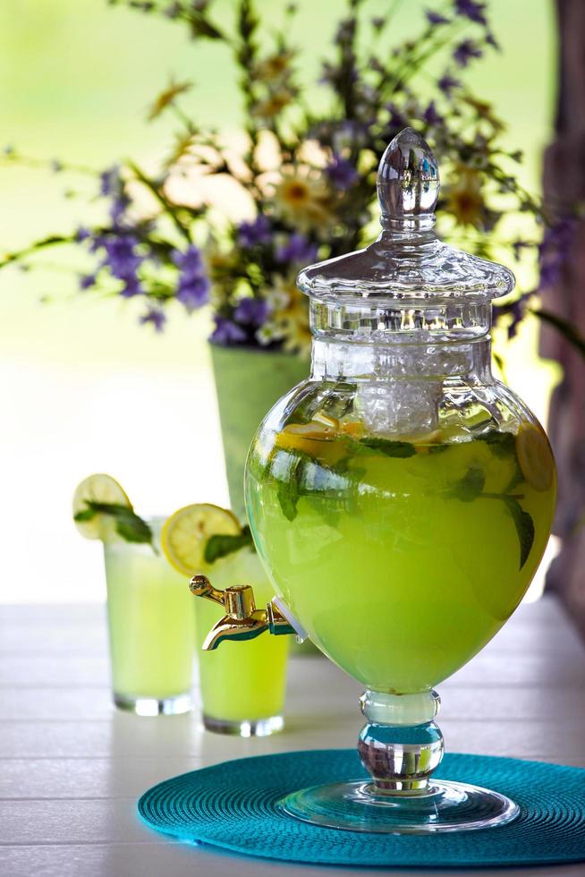 Clear glass jar full of fruit-infused beverage photo