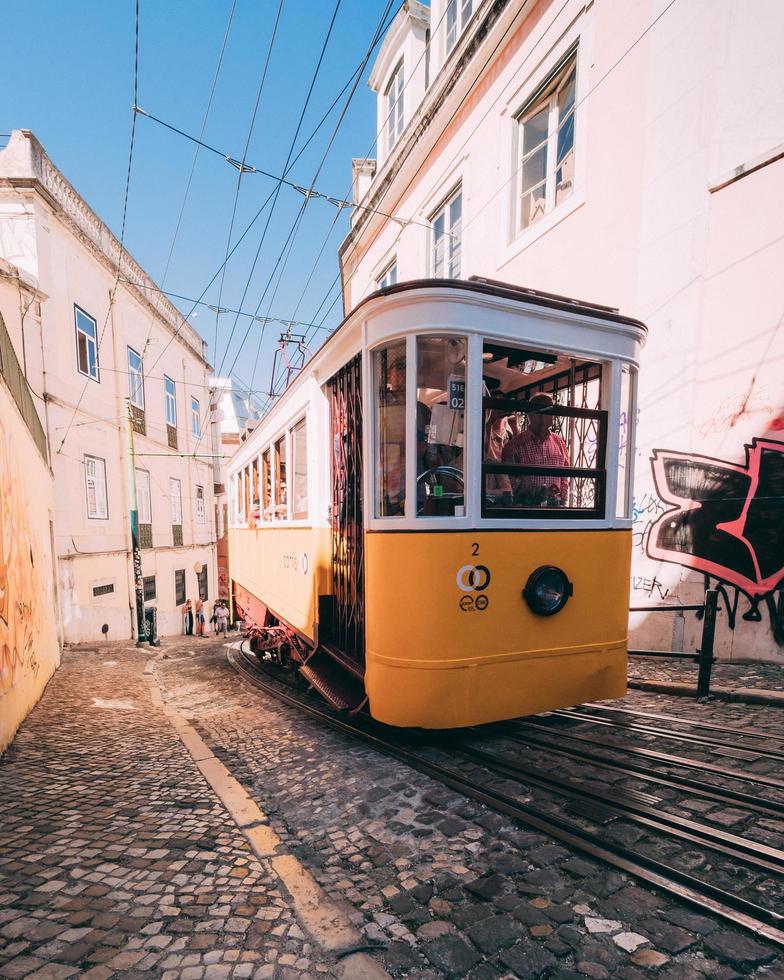 Yellow and white tram climbing up the hill photo