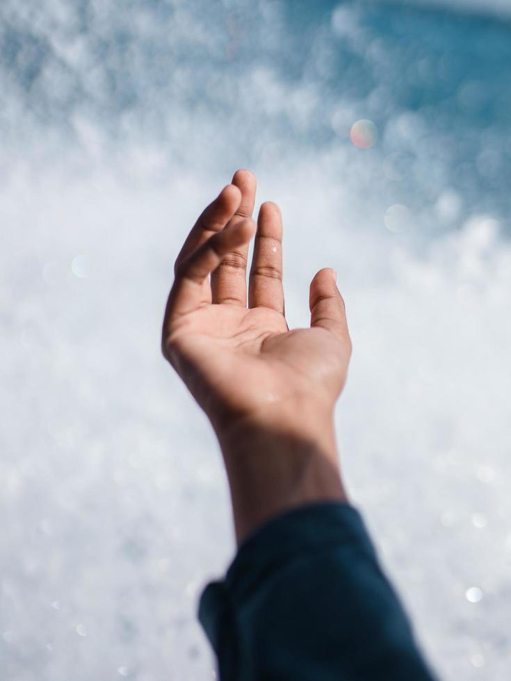 Hand in front of a wave photo