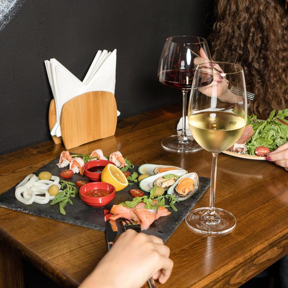 Two woman eating at a seafood restaurant photo