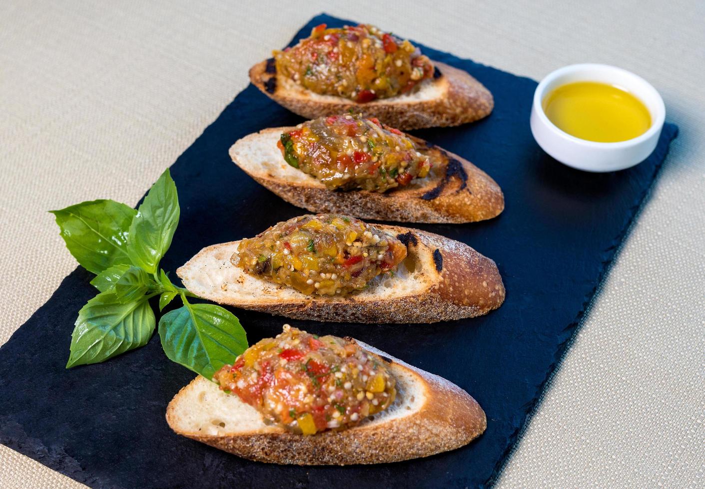 Eggplant salad on the small bread, tapas garnish photo