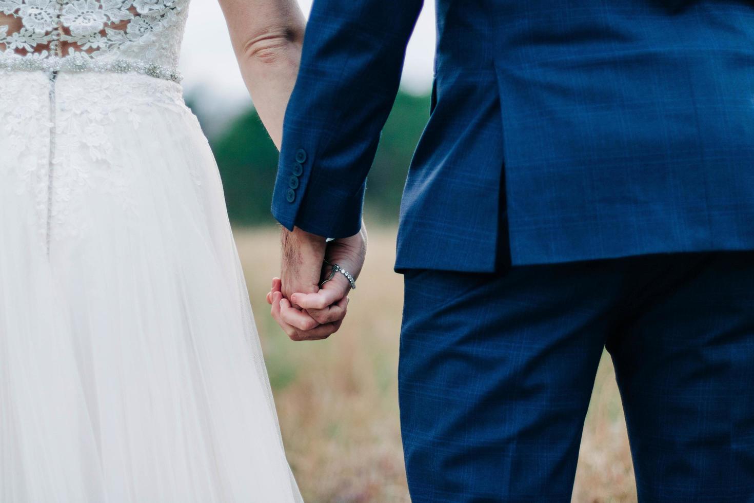 Close-up of married couple holding hands photo