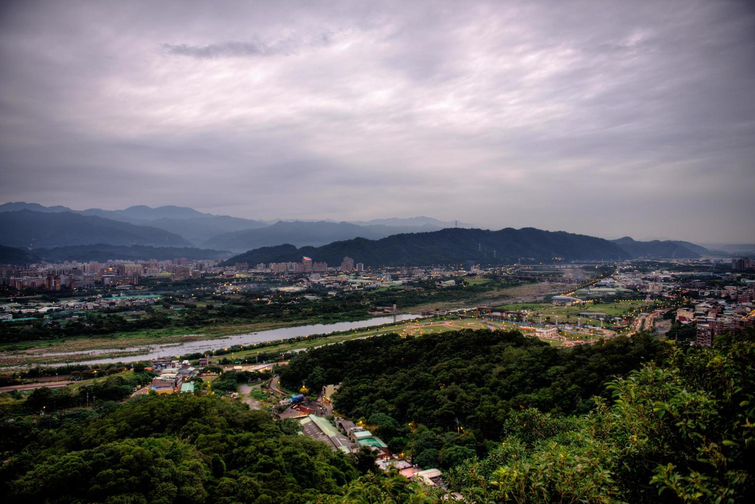 Aerial view of a road in a city under gray clouds photo