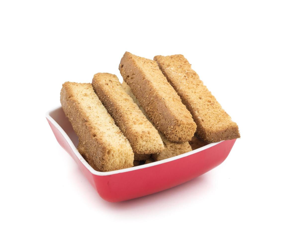 Palitos de tostadas francesas en un tazón rojo foto