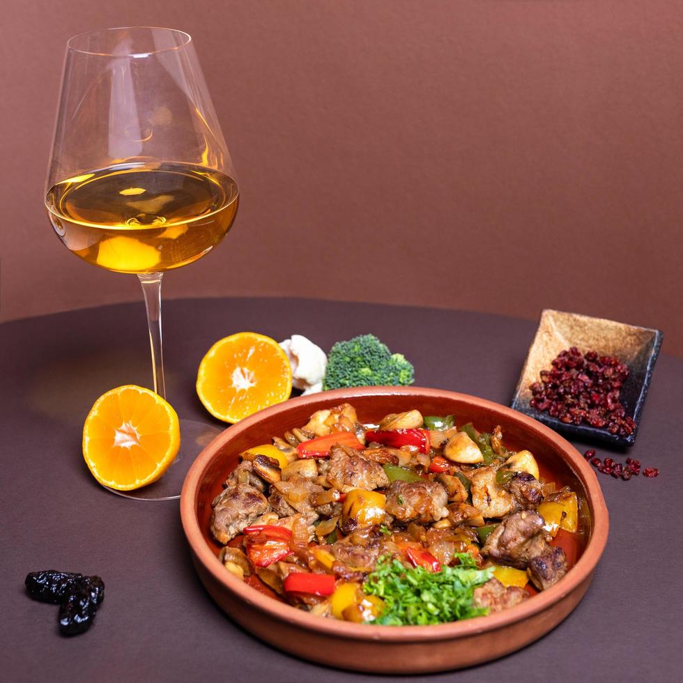 Tasty meat meal with white wine glass photo