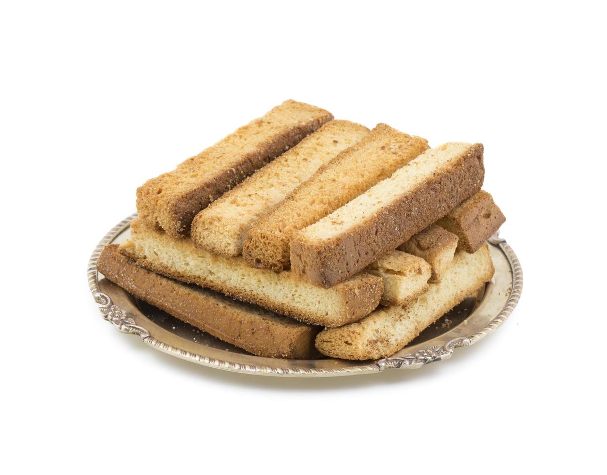 Stacked dry toast sticks on a plate photo