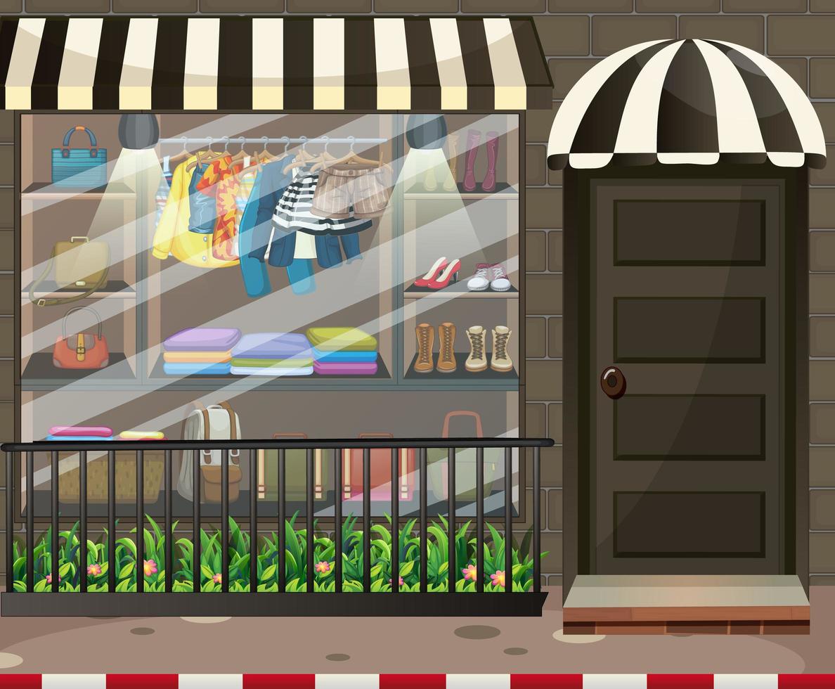 Front of clothing store showcase with clothes and accessories vector