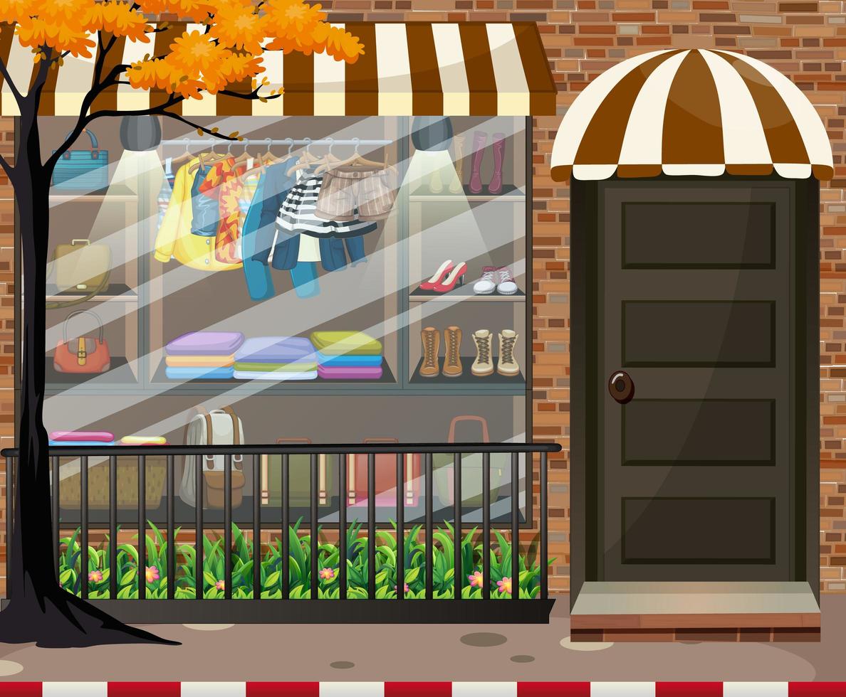 Front of clothing store showcase with clothes and accessories vector