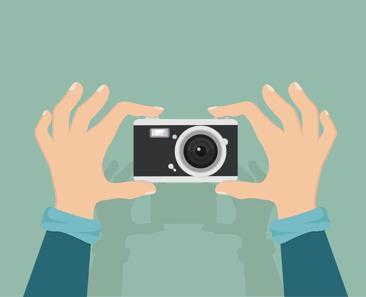 Hands holding a retro camera vector