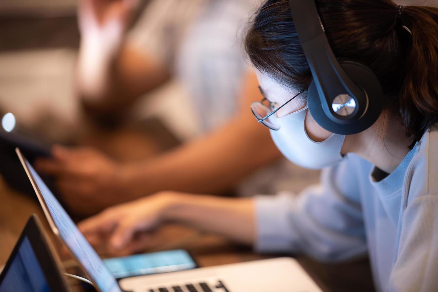 Creative worker wearing face mask while working photo