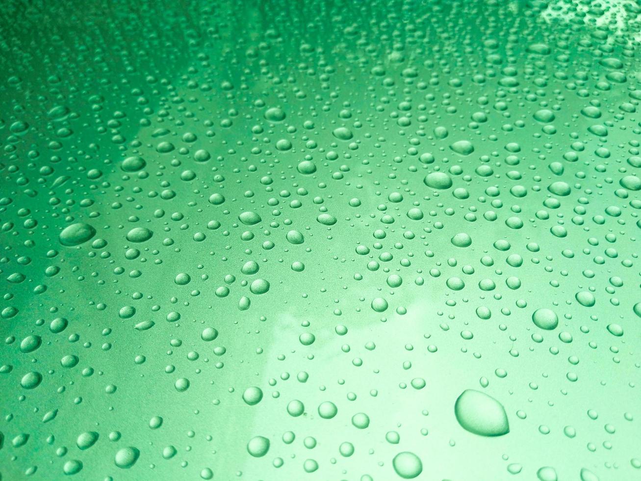 Close-up of rain drops on a translucent surface photo