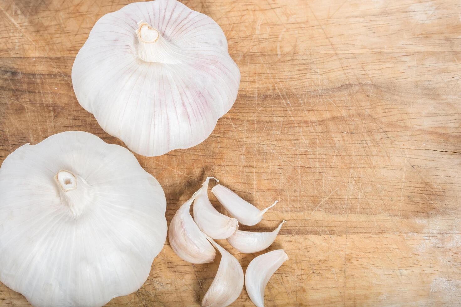 Garlic on wooden background photo