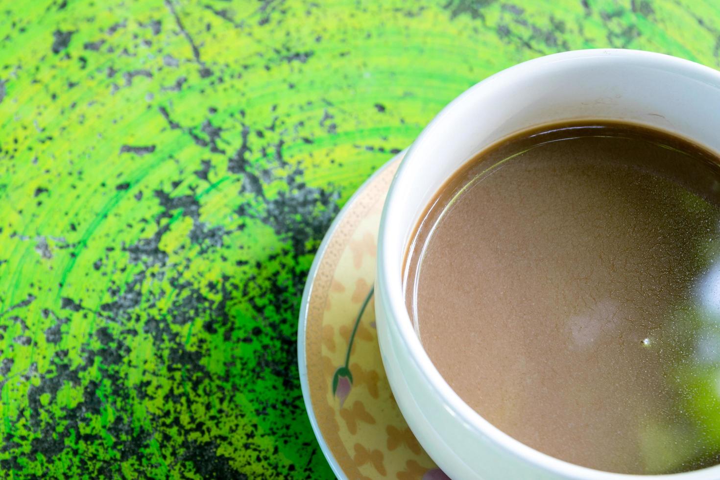 Hot coffee on green table photo