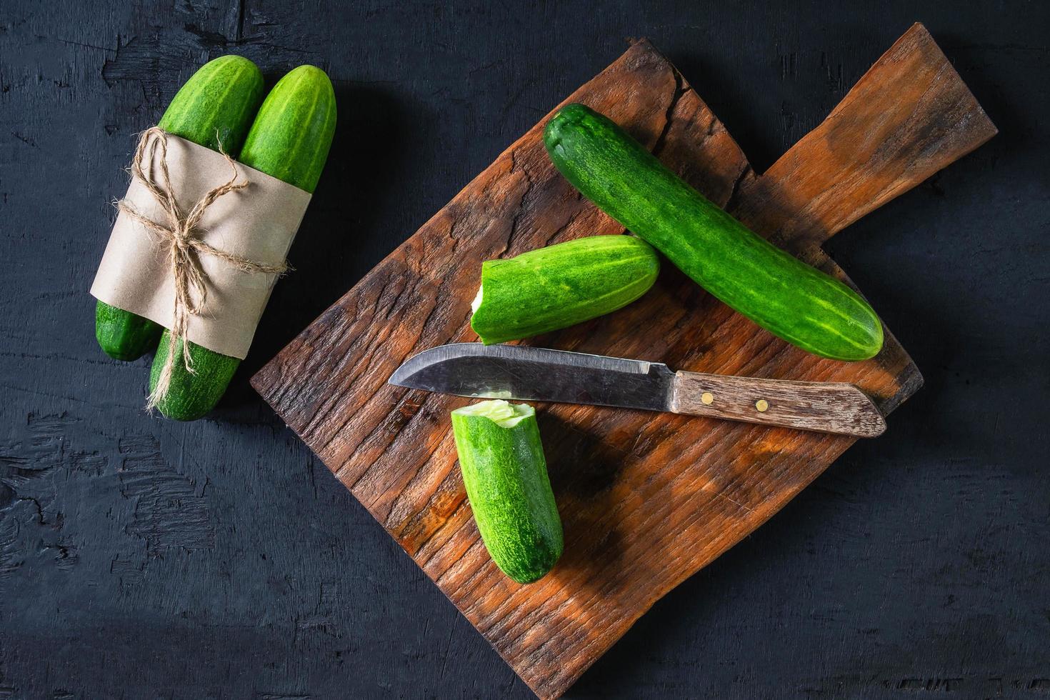 Fresh cucumber on a wooden cutting board photo