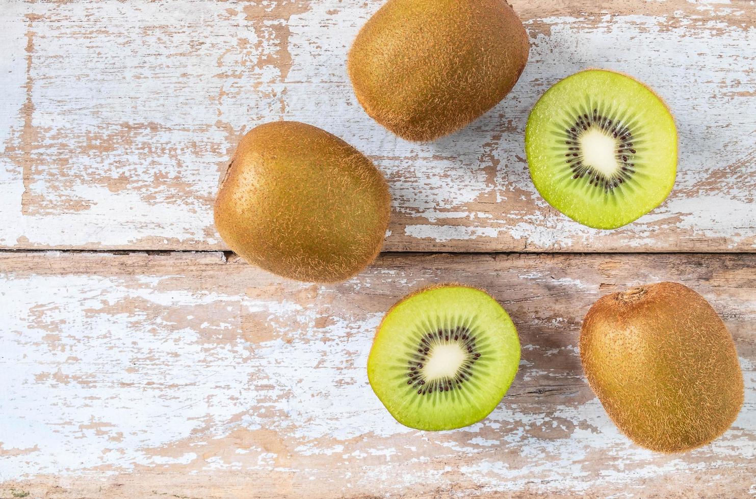 Kiwi fruit on wooden background photo
