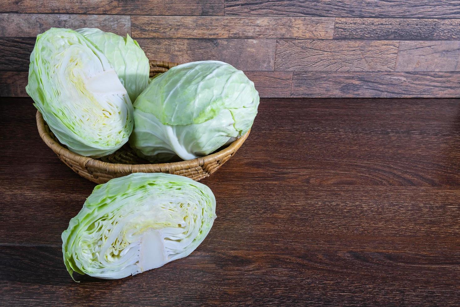 Cabbage in a basket on a wooden table photo