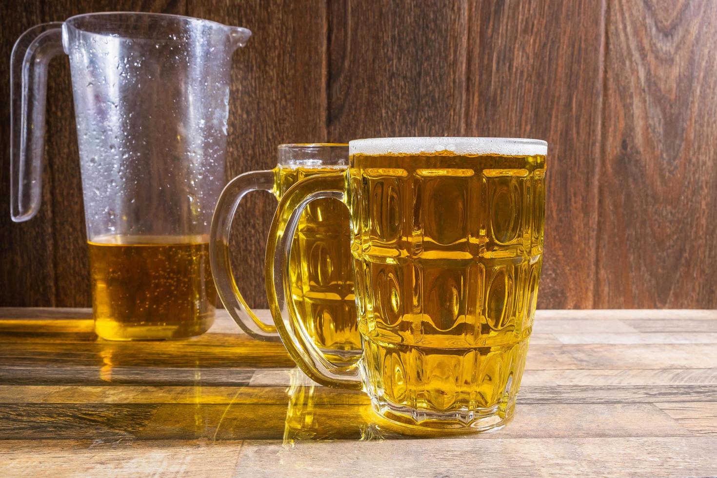 Pitcher and mugs of beer photo