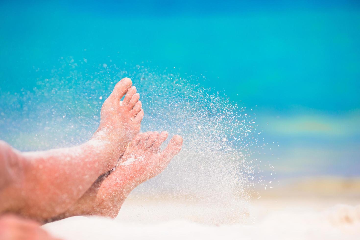 Person kicking off sand photo