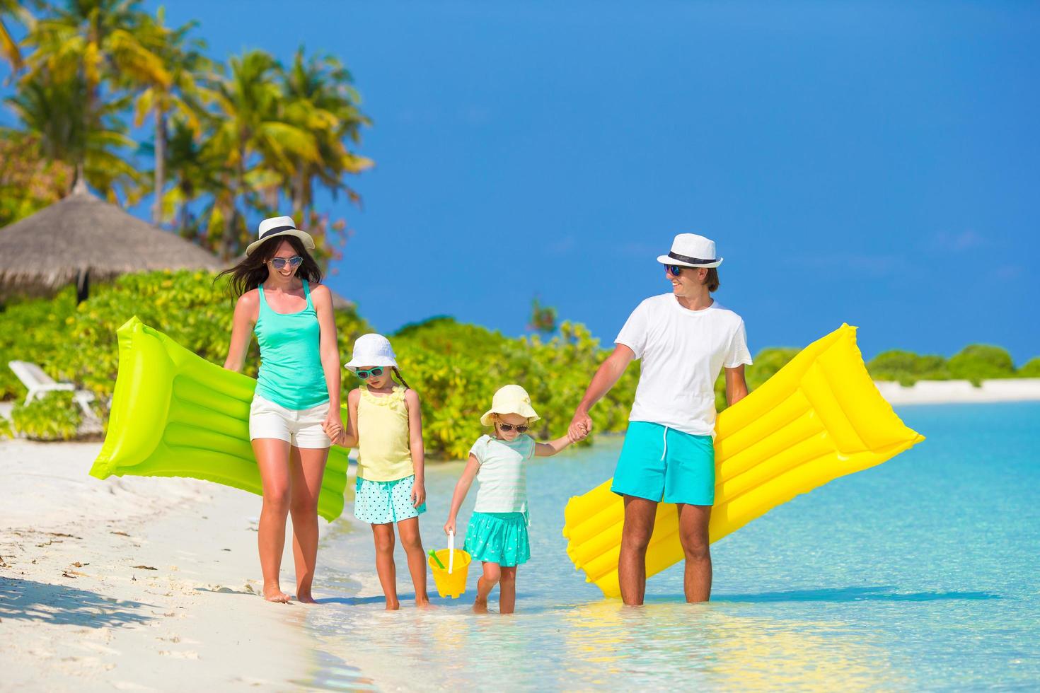 Family with floaties at the beach photo