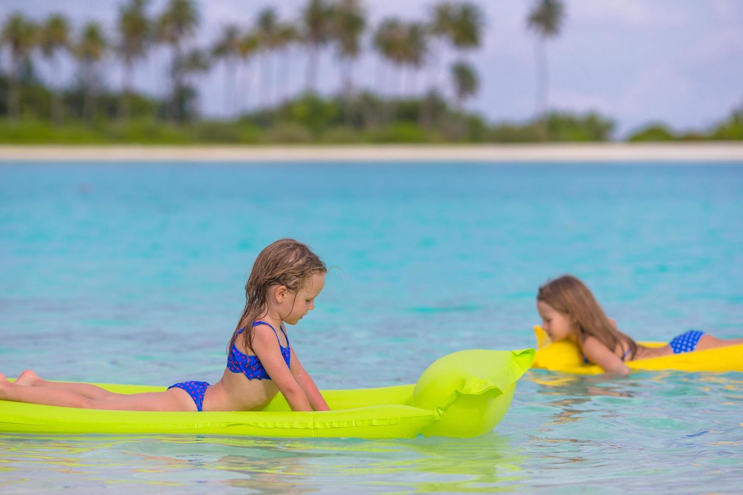 Two girls on floaties in the water 1738881 Stock Photo at Vecteezy