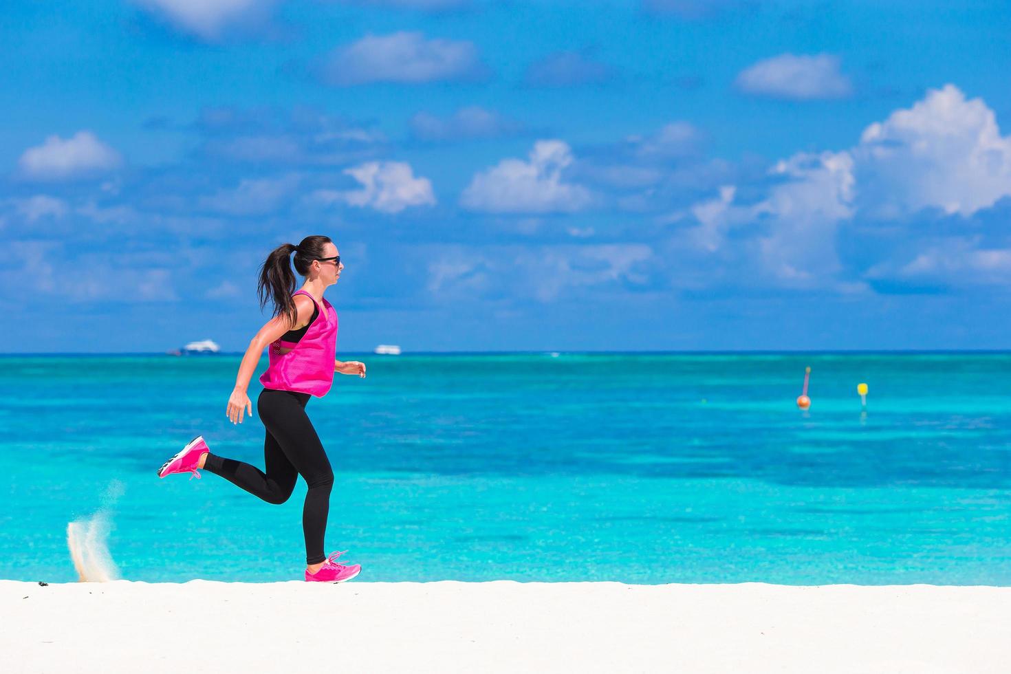 Woman running on a beach photo