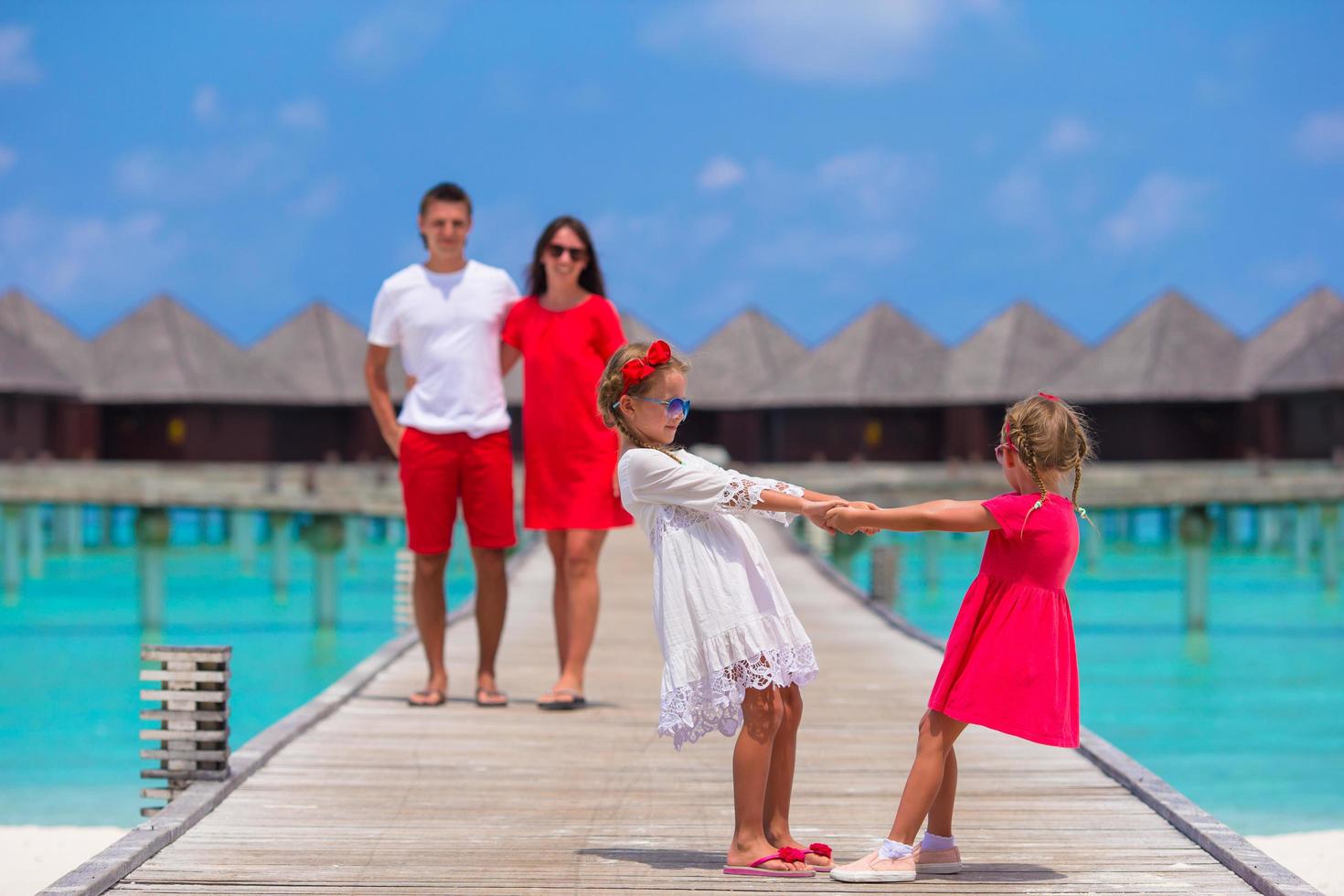 Maldives, South Asia, 2020 - Kids playing with parents in the background photo