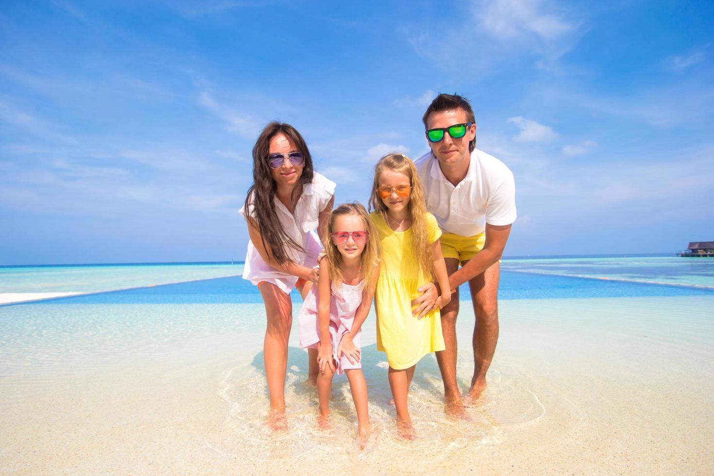 Family in water at a tropical beach photo