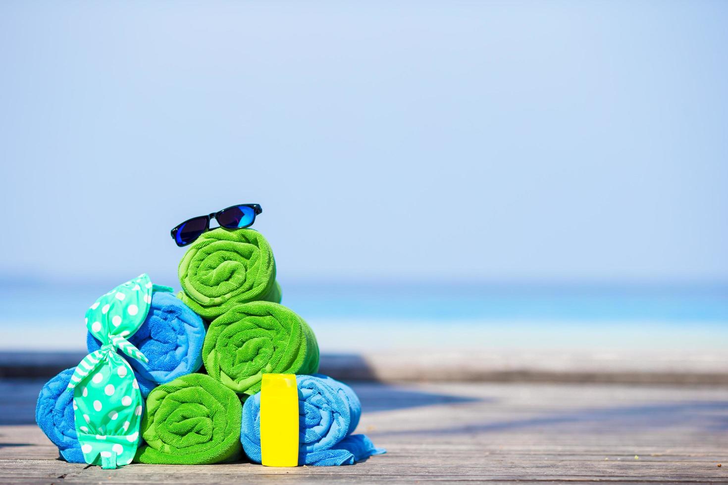 Stacked towels and sunglasses photo