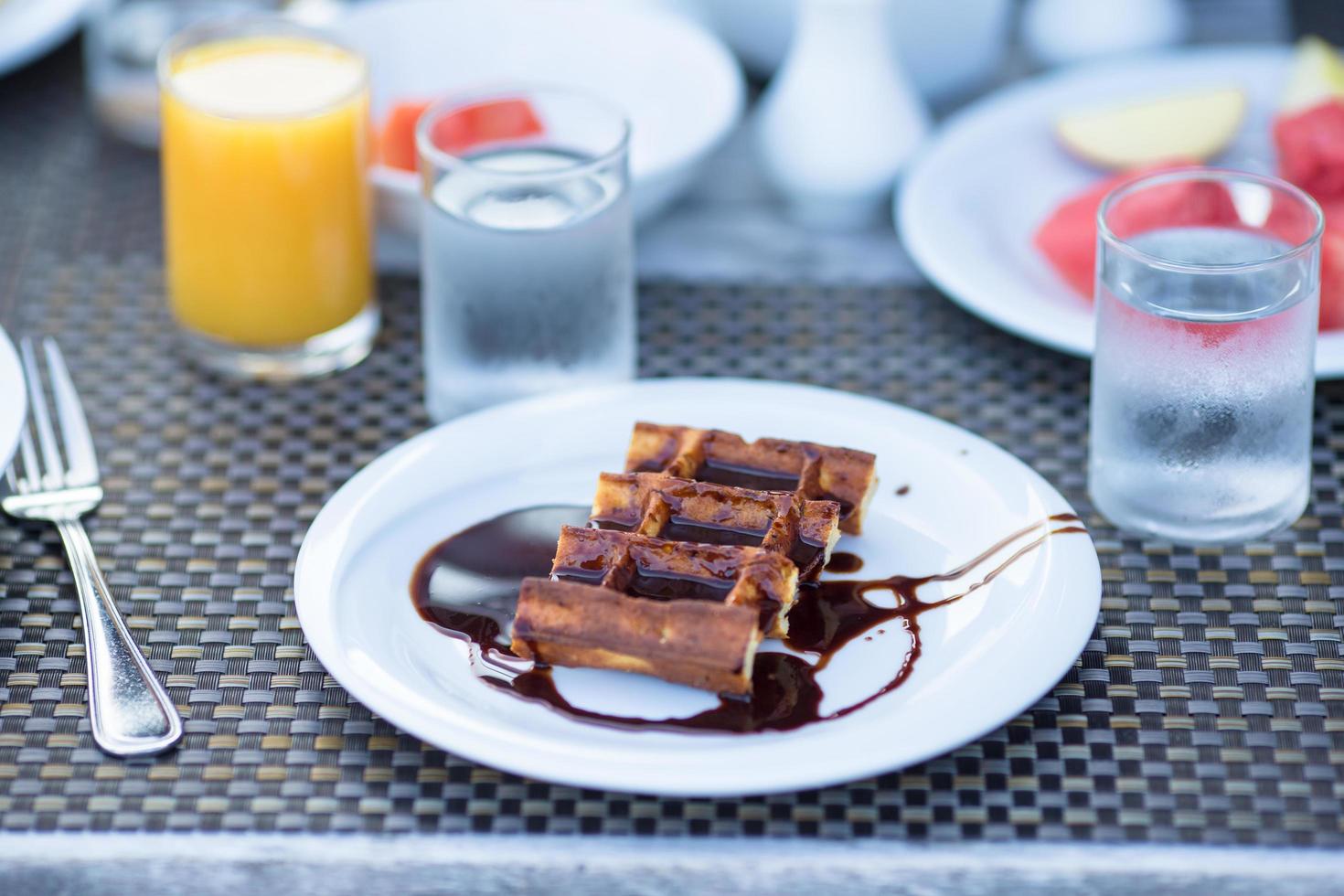 Plate with waffles and chocolate on it photo