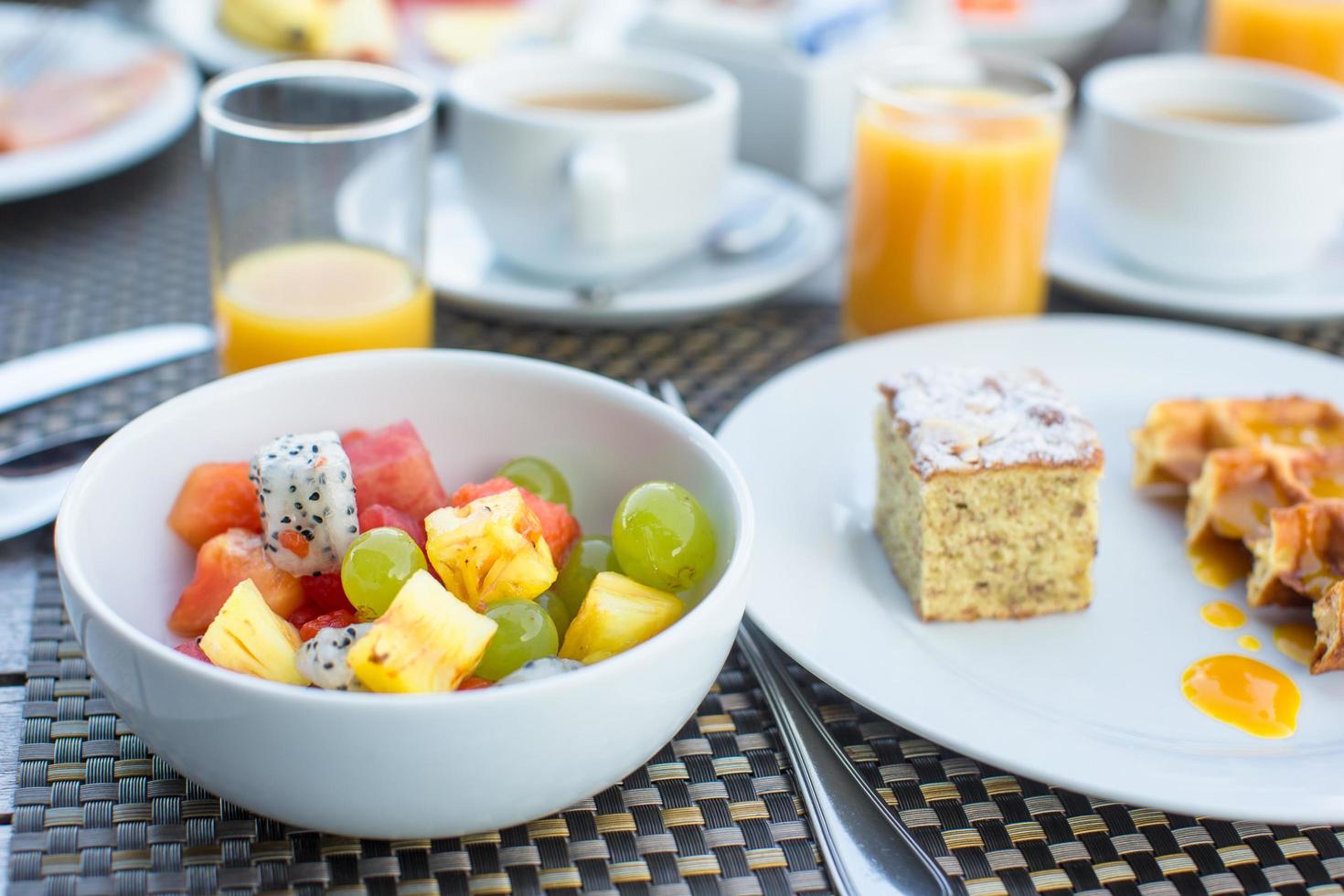 Bowl of fruit at breakfast table photo